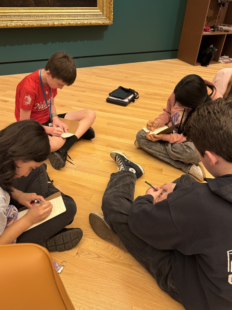 students working together in a group to discuss what they see in a painting