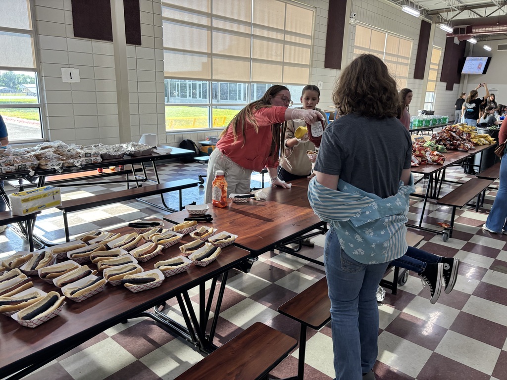 Mrs. Brown serving hot dogs to students and families at Steam night.