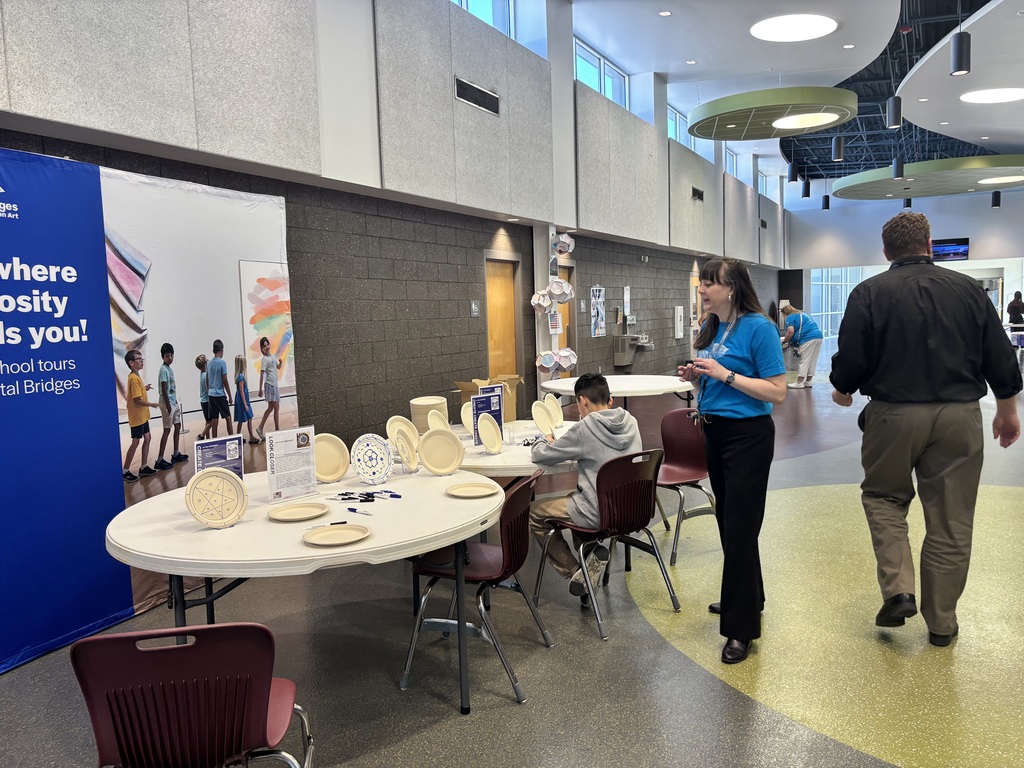A student working on a plate art project set up by the Crystal Bridges Museum.