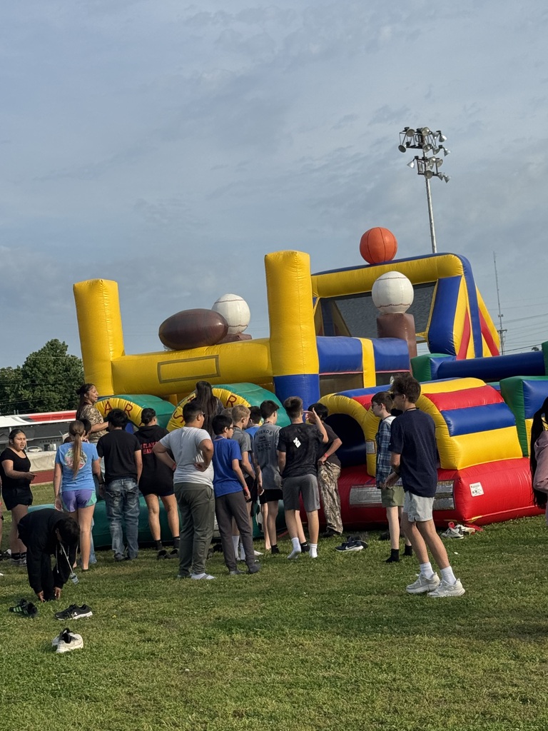 Group of students lined up waiting to run through the inflatable obstacle course. 