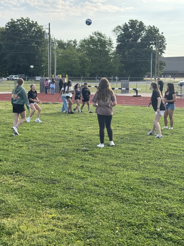A group of girls playing volleyball.