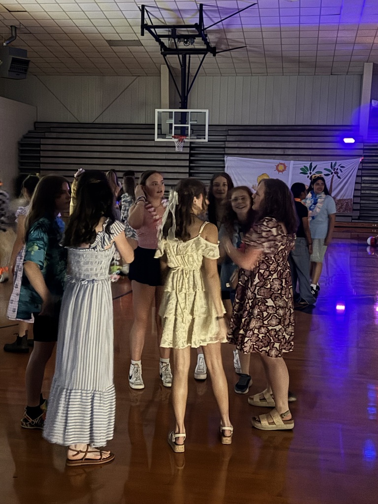 A group of 8th grade students dancing and having a good time at the 8th grade luau.