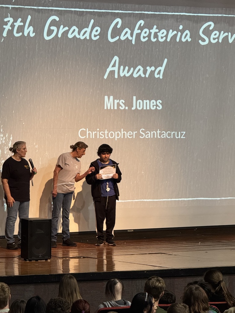 A student receiving a reward for his service.