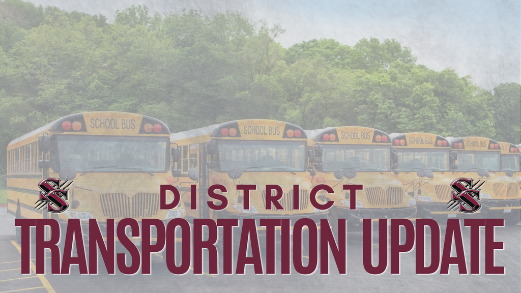 Four yellow school buses in a row, with text overlay "DISTRICT TRANSPORTATION UPDATE" in front of blurred trees.