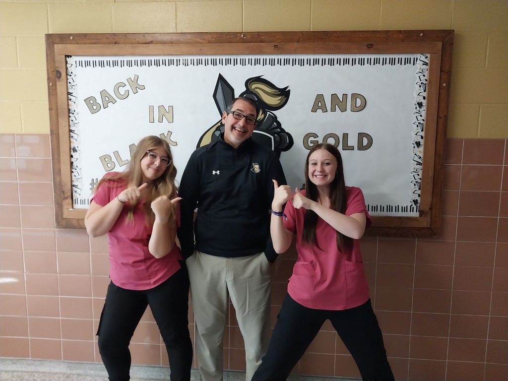 Mr. Rice with two students in pink
