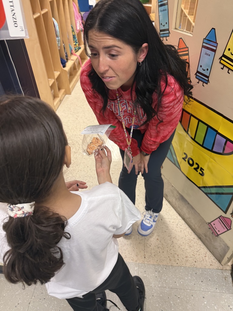 student giving treat to a teacher