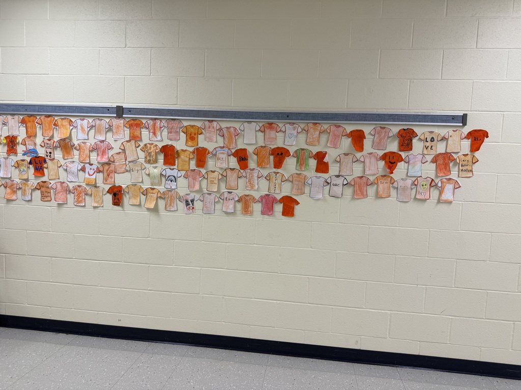 orange paper shirts hanging in hall