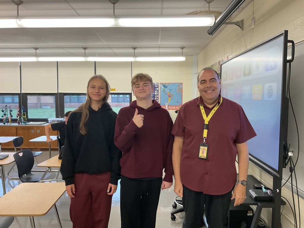 Mr. VanDette & students in maroon and black
