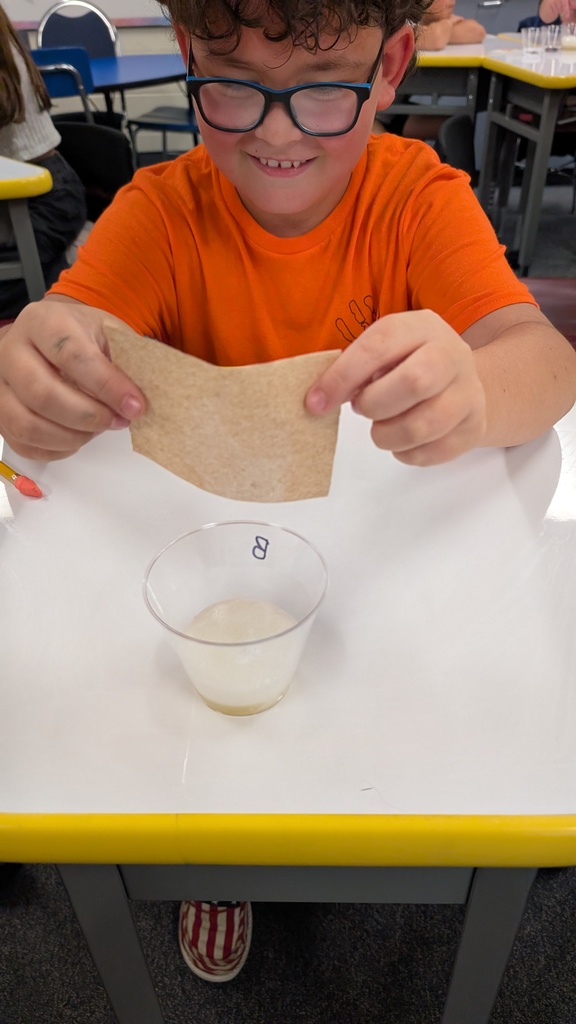 student pouring into a cup