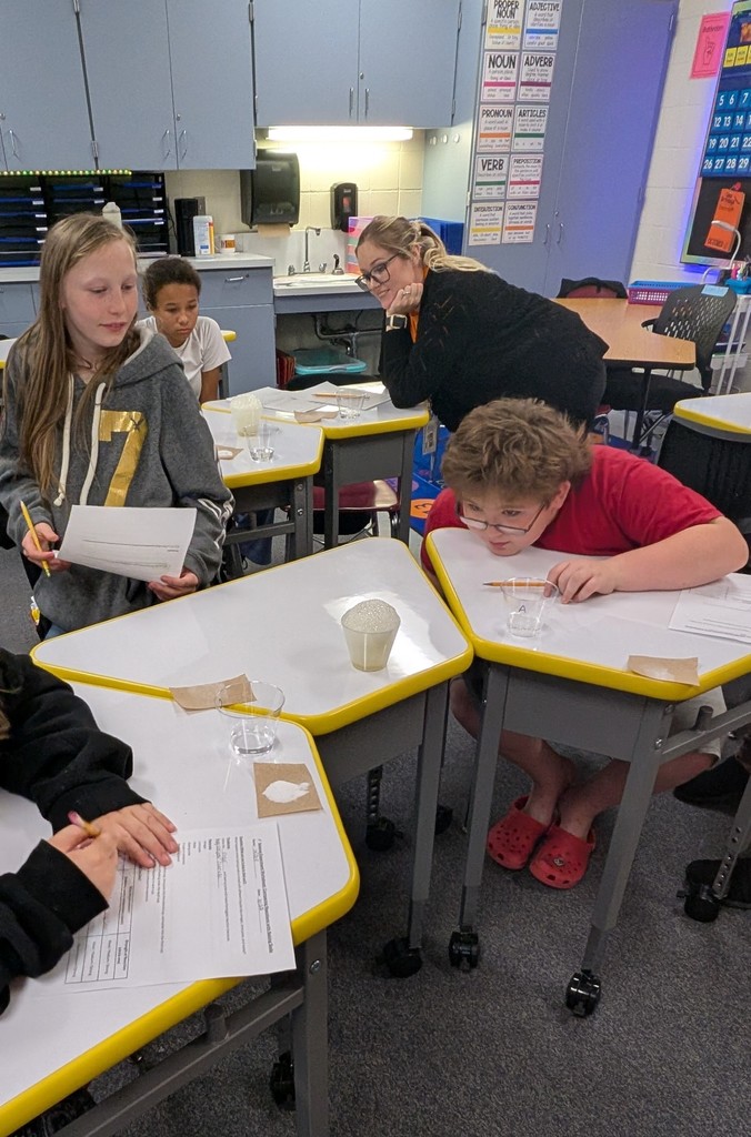 Student at desk watchin bubble reaction