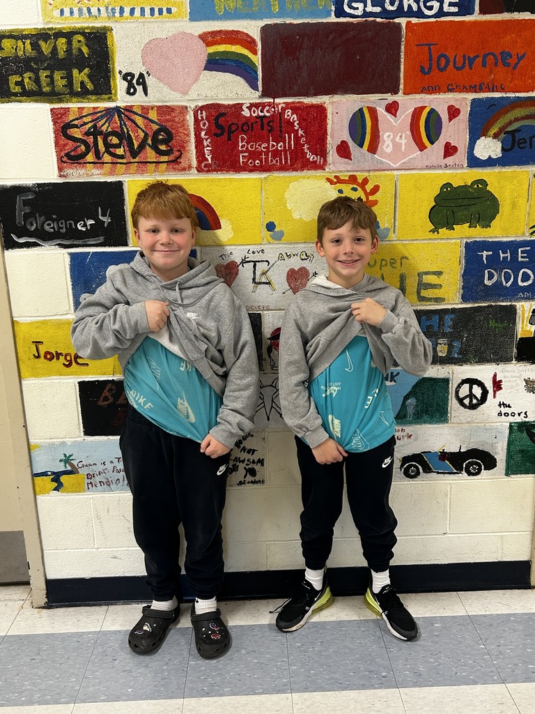 students in gray hoodies and blue shirts