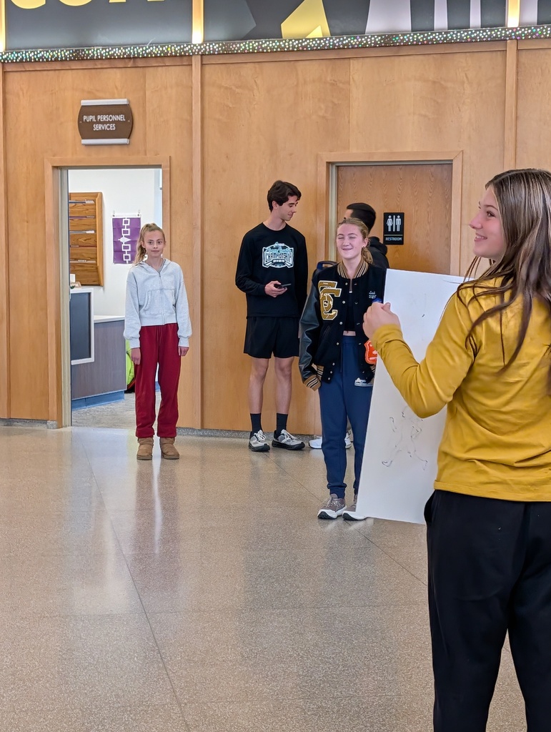 Leah in lobby with students