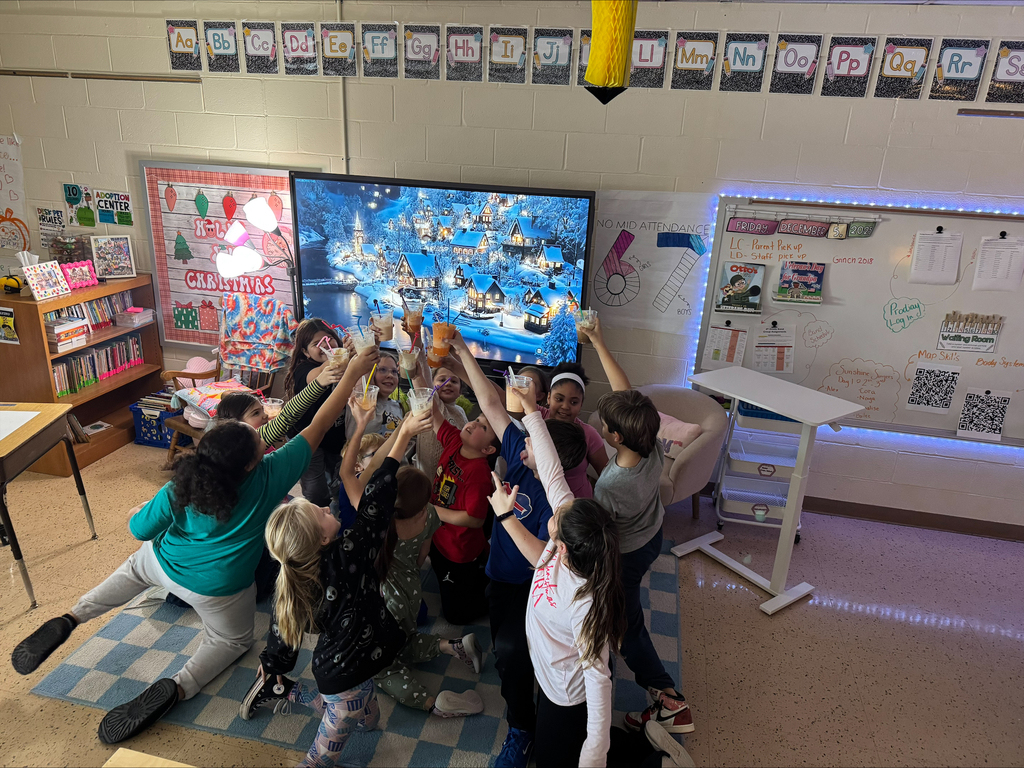 A circle of children hold up their float glasses to cheers.