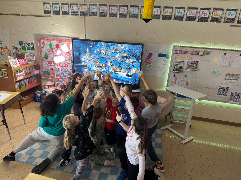 A circle of children hold up their float glasses to cheers.