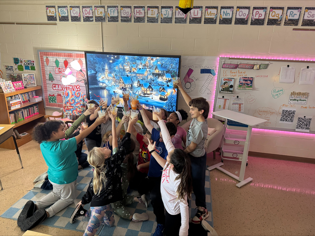 A circle of children hold up their float glasses to cheers.