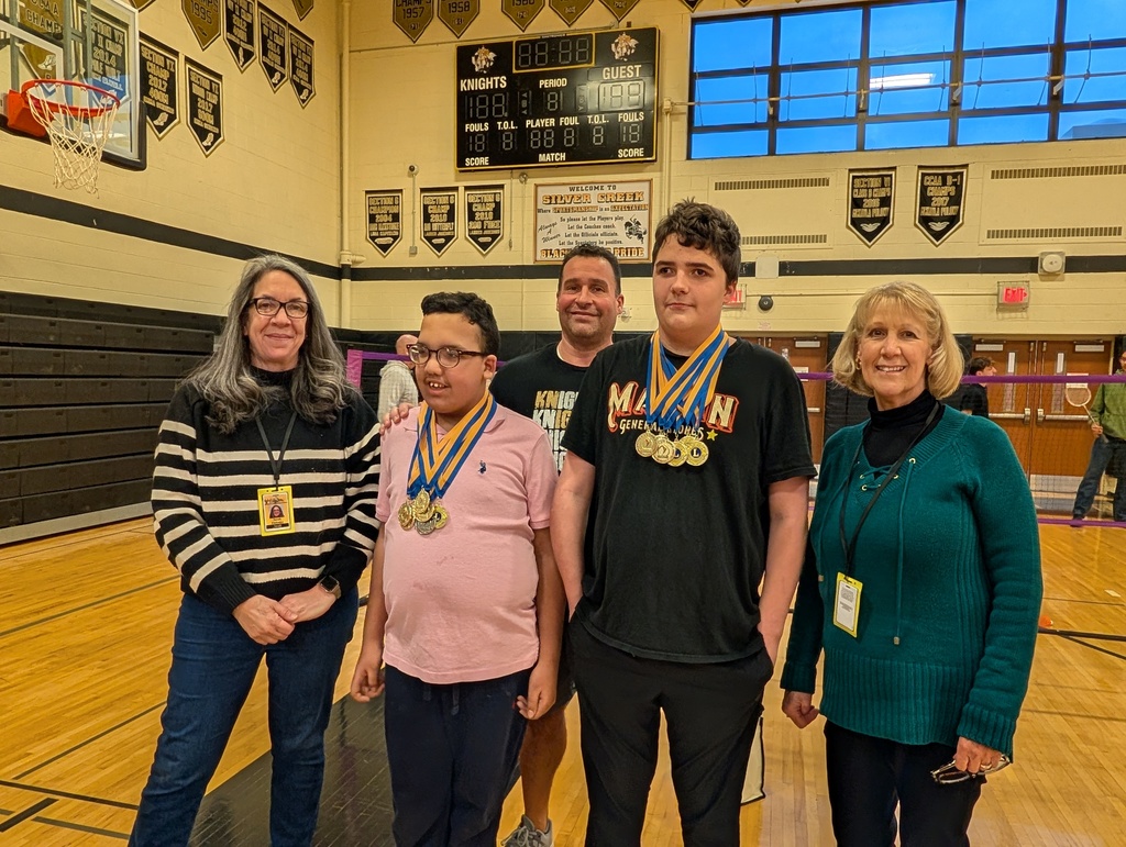 Joe and Carter wearing medals in gym with Mrs. Oyer & Mr. Forenzo