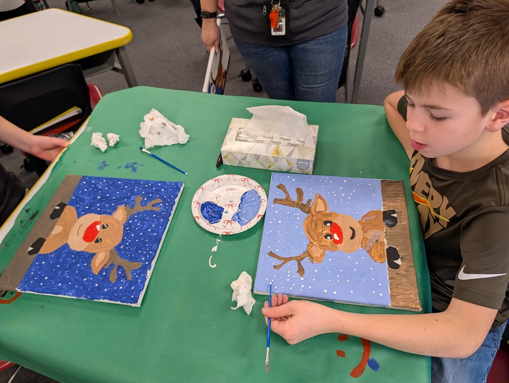 boy at desk painting