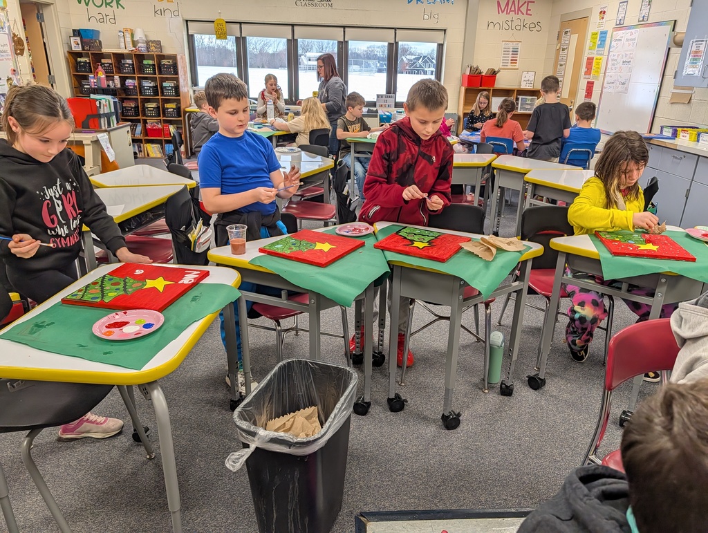 students at table painting trees