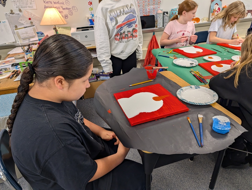 boy at desk looking at painting