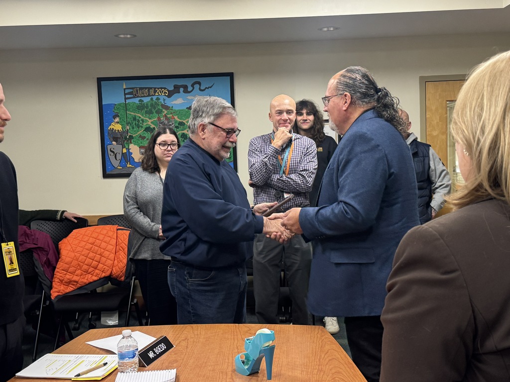 Mr. Bogosian and Mr. Janisch shake hands