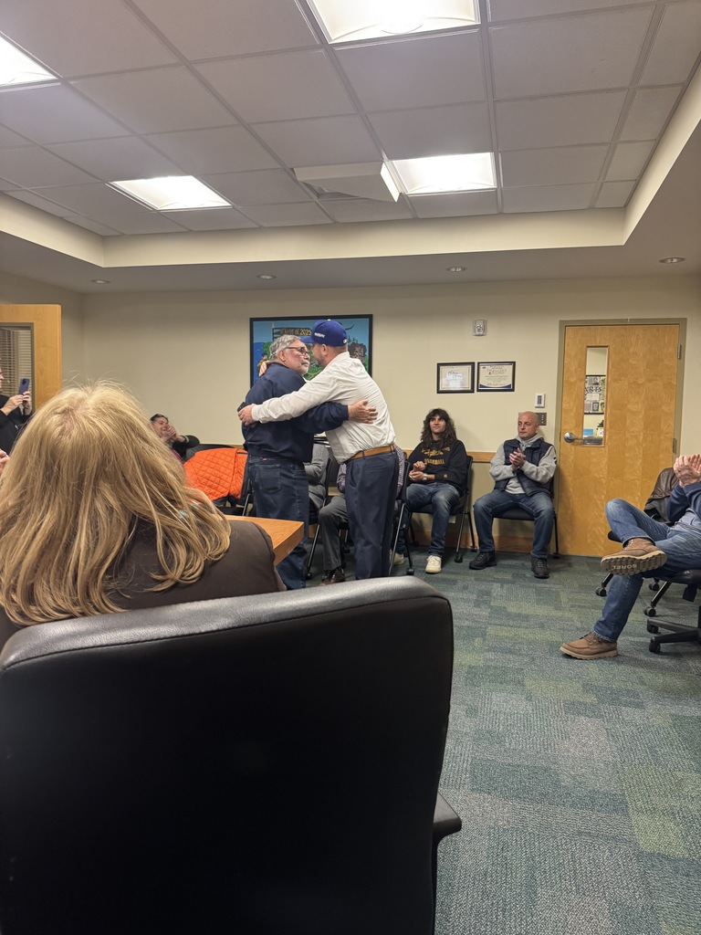 Coach Kelley hugs Mr. Janisch