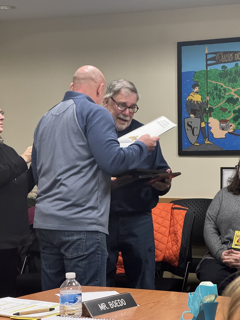 Mr. Helmer presents Mr. Janisch with award