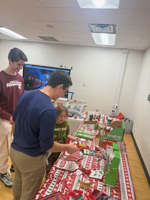 boys looking at shopping table with girl