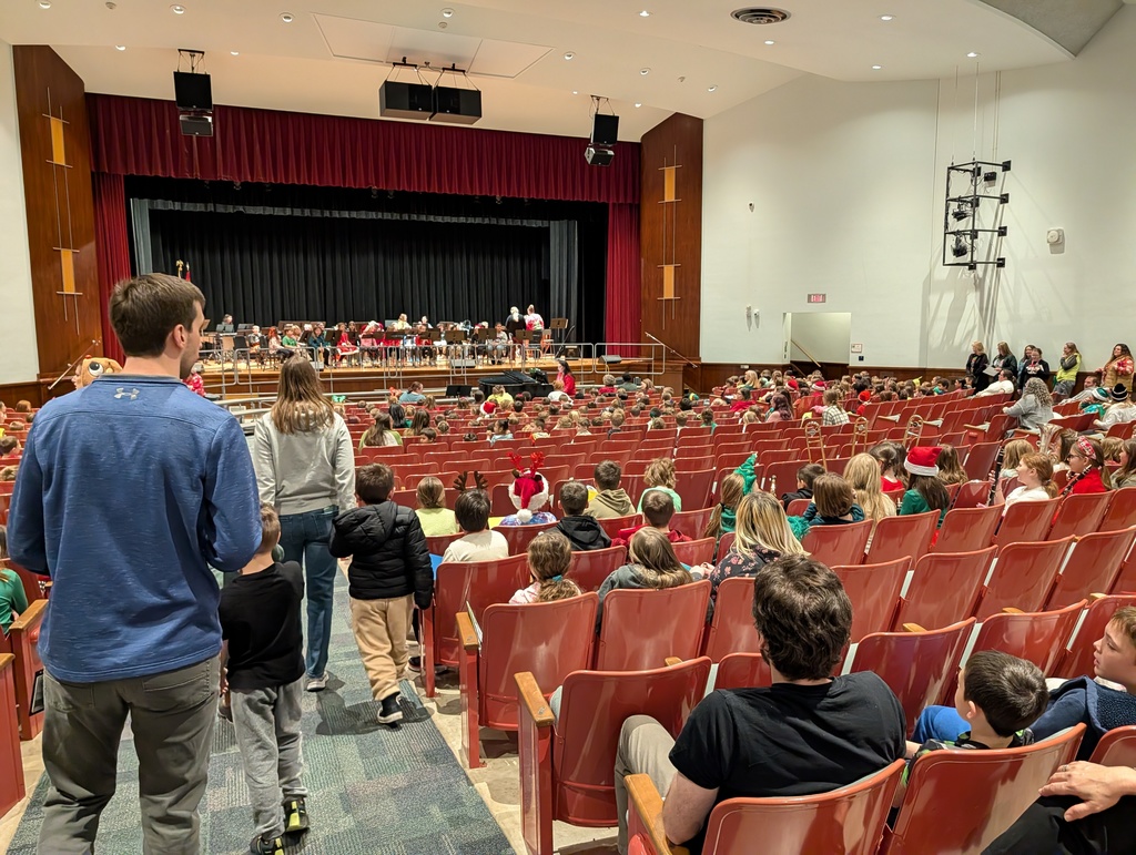 students gathering in auditorium for concert