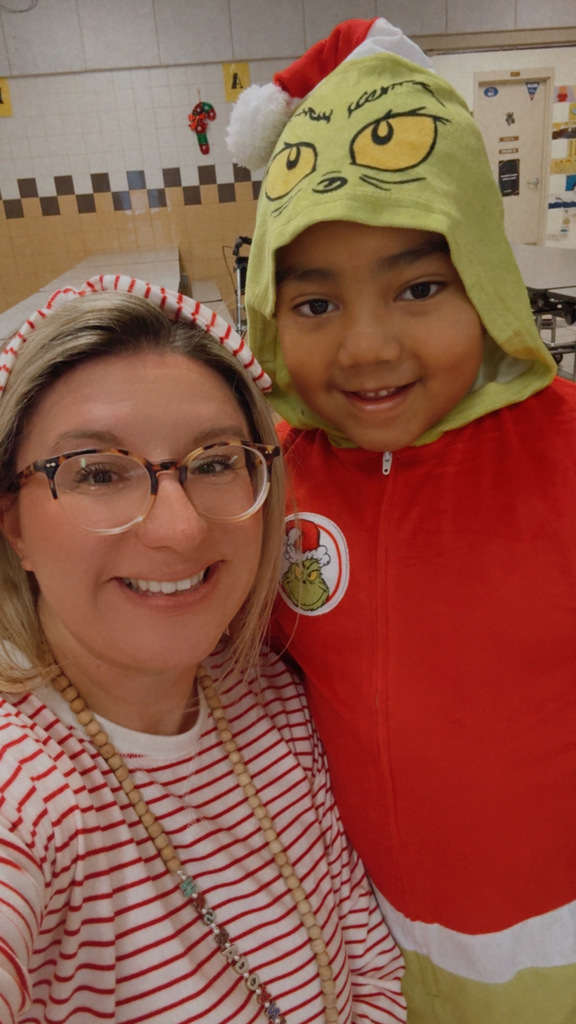 Mrs. Radoani and student in Christmas PJs