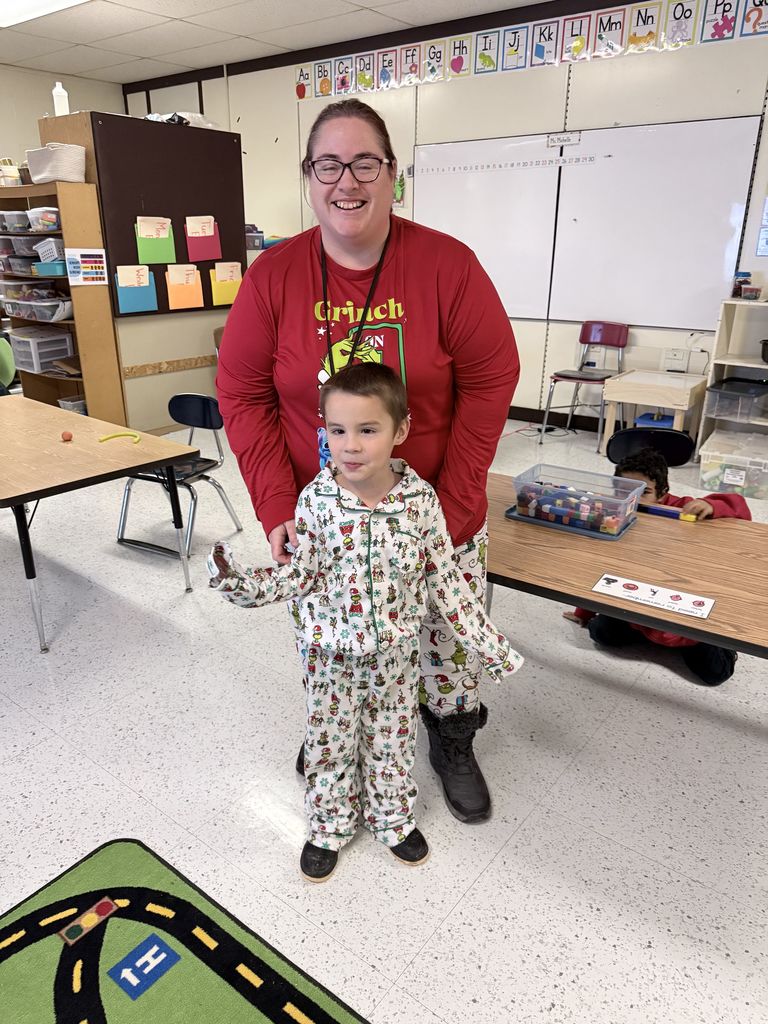 Staff and student in Grinch PJs