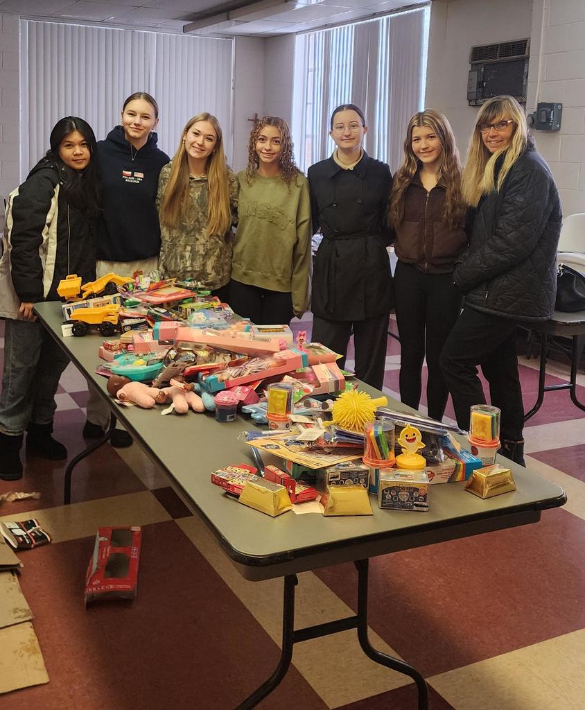 Key CLun students around table full of toys