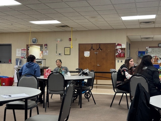 Students sit with elders.