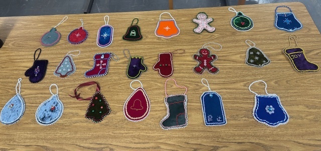 Handmade felt ornaments laid out on a table. 