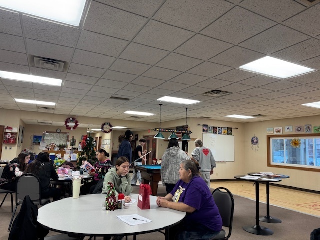 Students sit with elders.