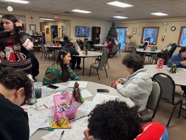 Student sits with an elder.