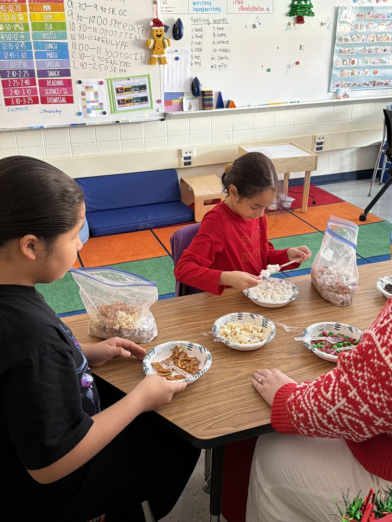 students holding bowls of marshmallows and pretzels