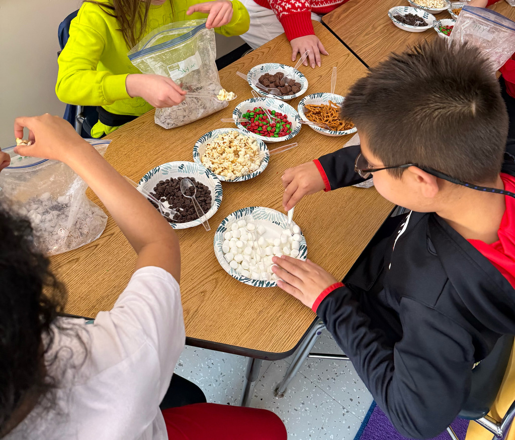 students hands reaching for mis ingredients