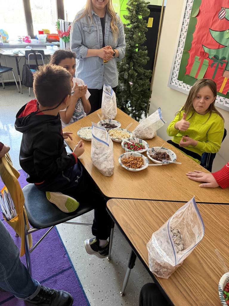 students at table making snack mix