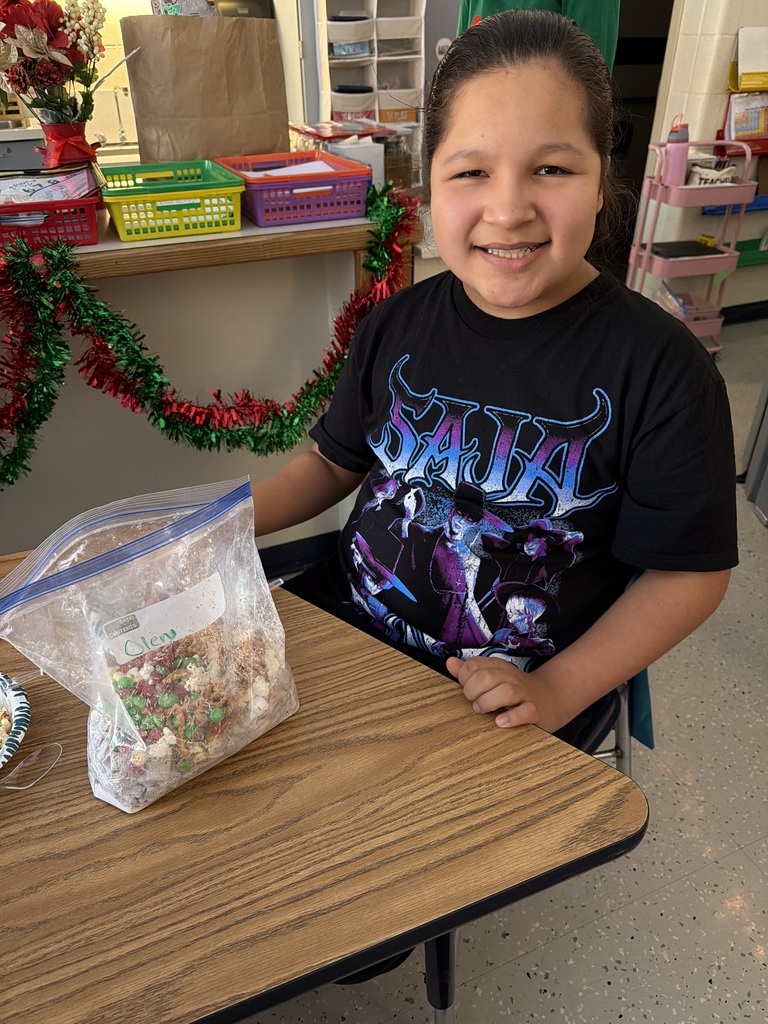Student smiling with bag of snack mix
