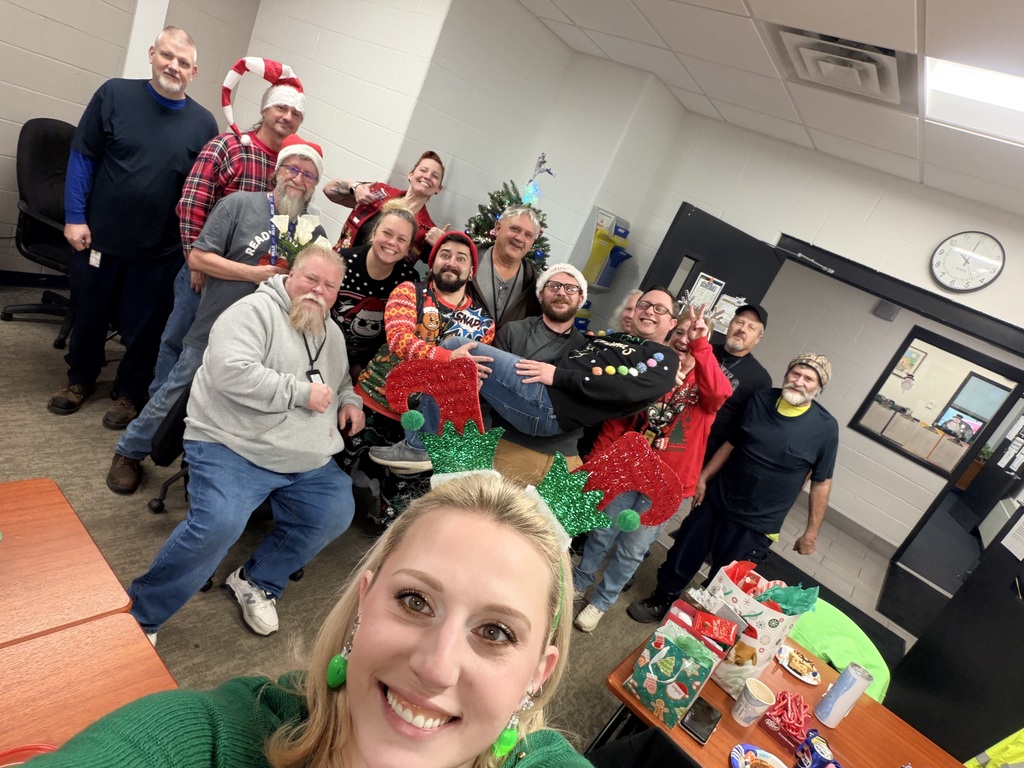 Transportation Dept smiling in front of Christmas tree