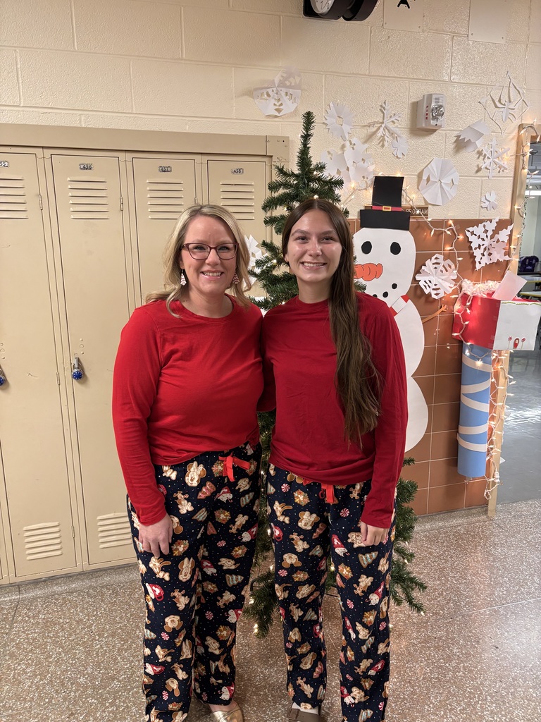 student and teacher in matching holiday pjs