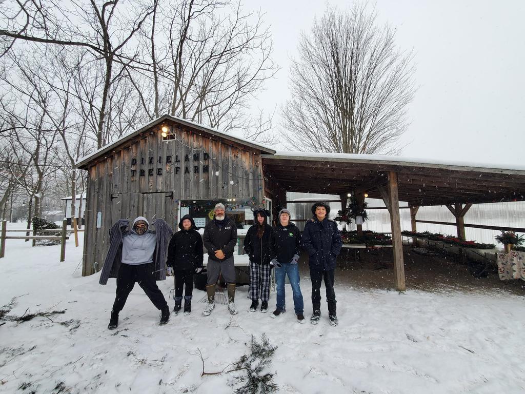 Students pose for a photo at the tree farm. 