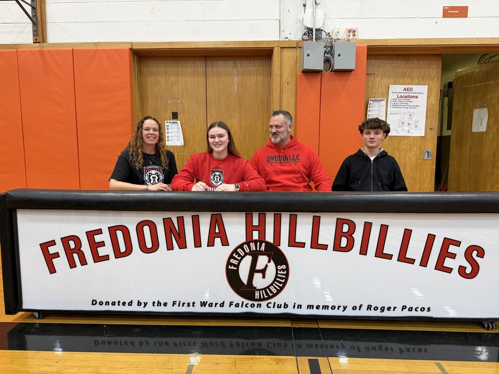 Kimmy smiling at table with her family