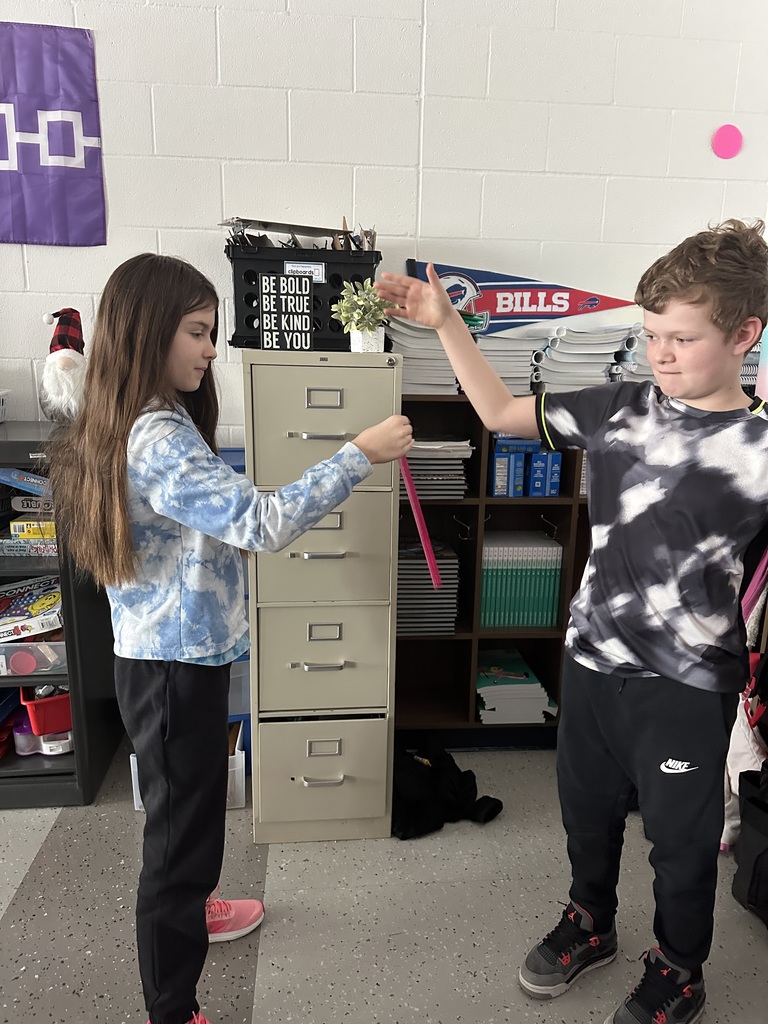 girl catching ruler as boys drops it