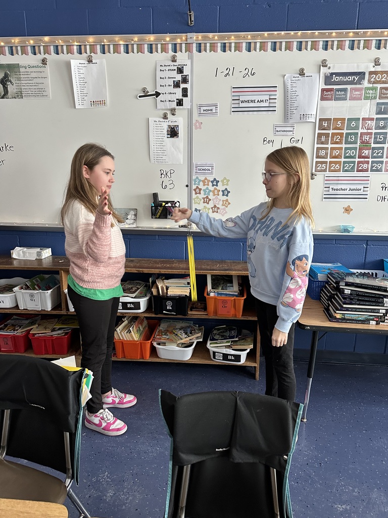 two girls watching ruler drop