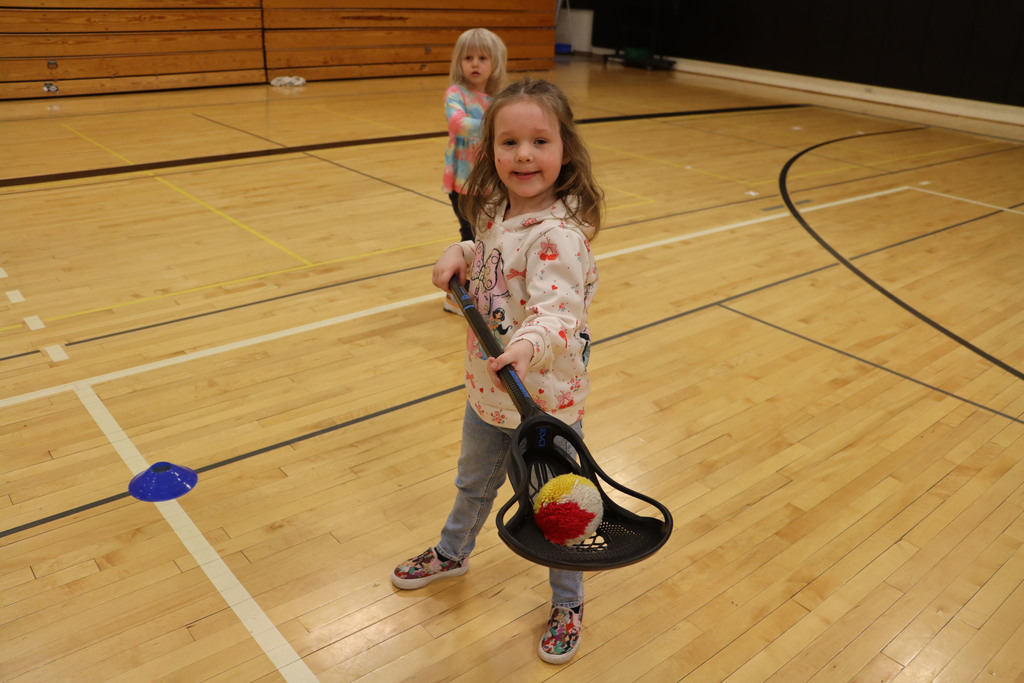 A student shows off how she picked up a ball using only her stick. 