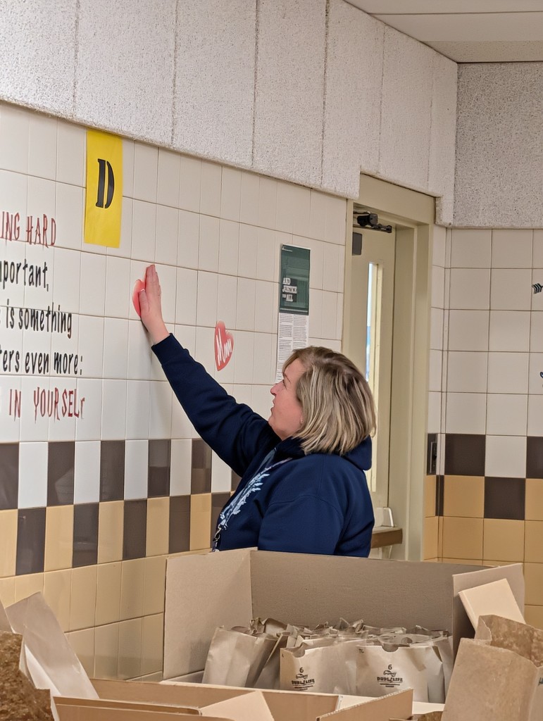 Barb hanging hearts on the wall