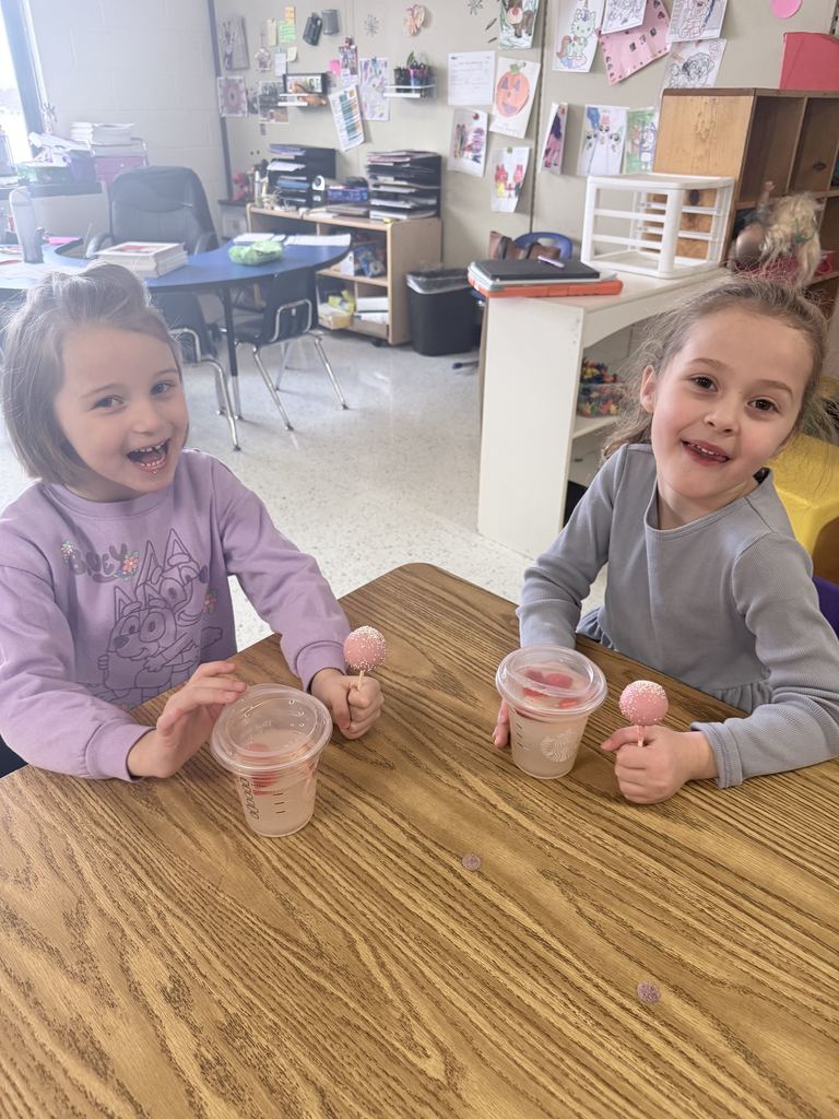 student smiling with special drink and cake pops