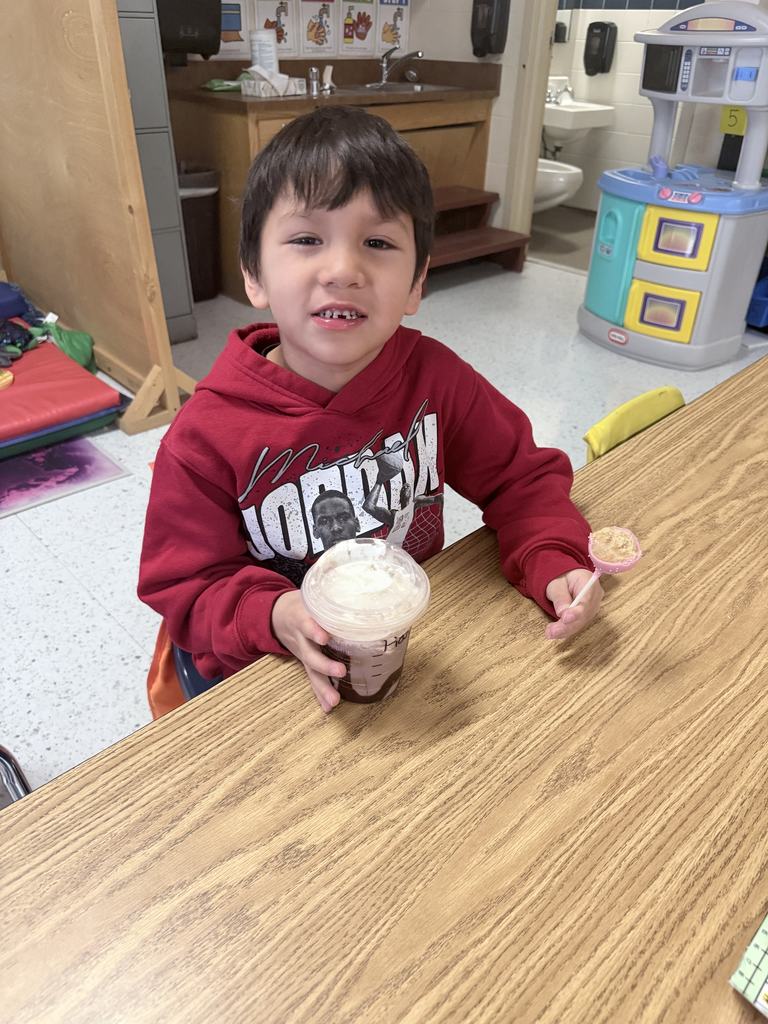 student smiling with special drink
