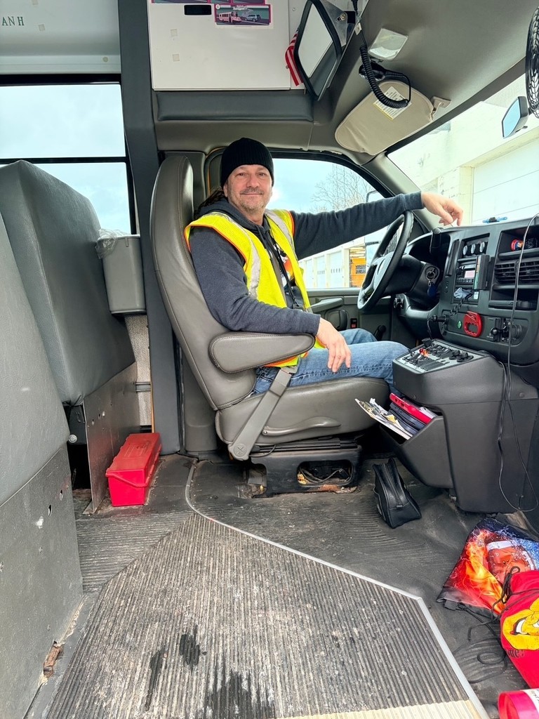 Mike Pantano sitting in the bus driver's seat 